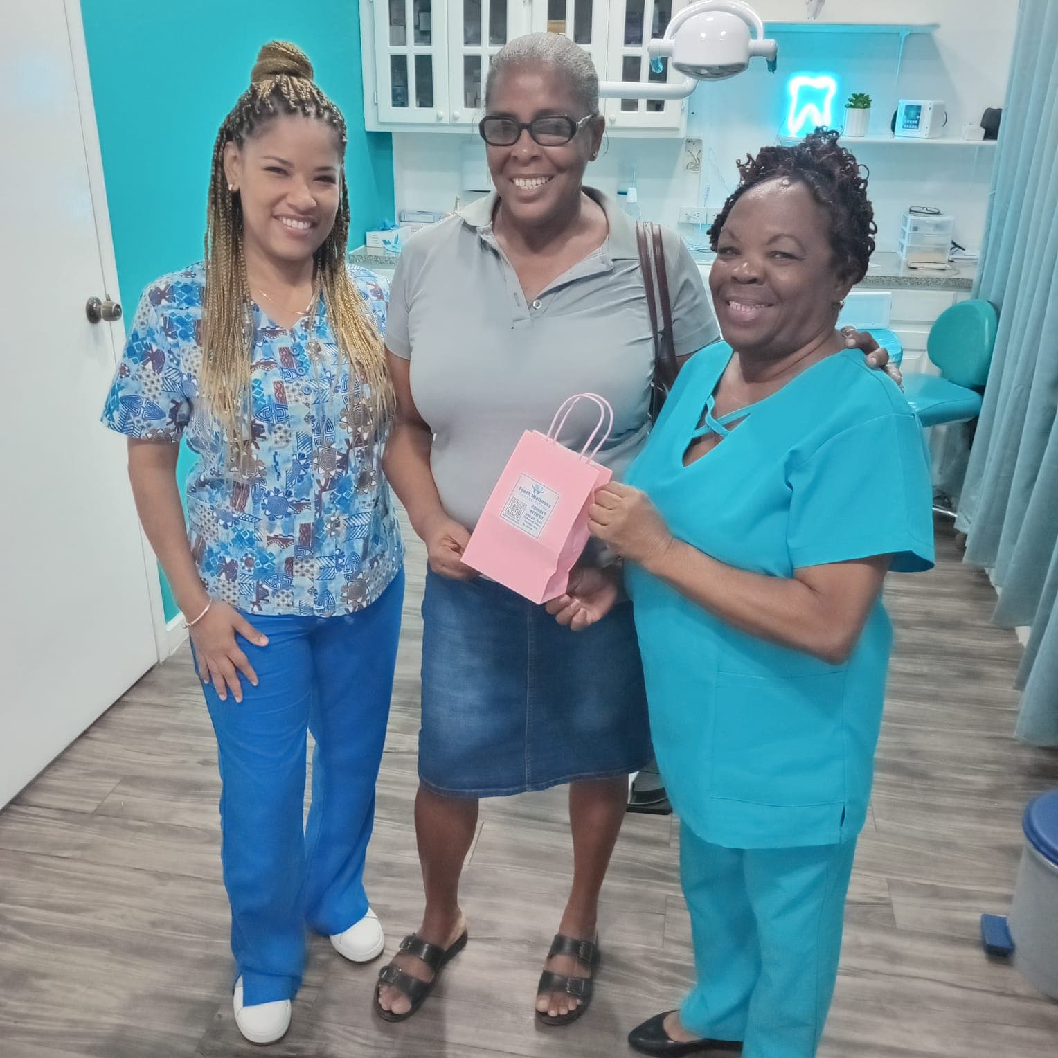 Dental care team and pacient smiling